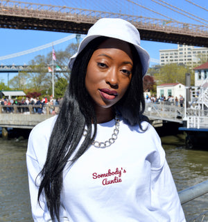 women in white crewneck in front of bridge